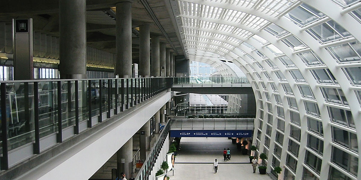 Modern multi-level atrium in a Hong Kong complex with curved glass architecture and walkways