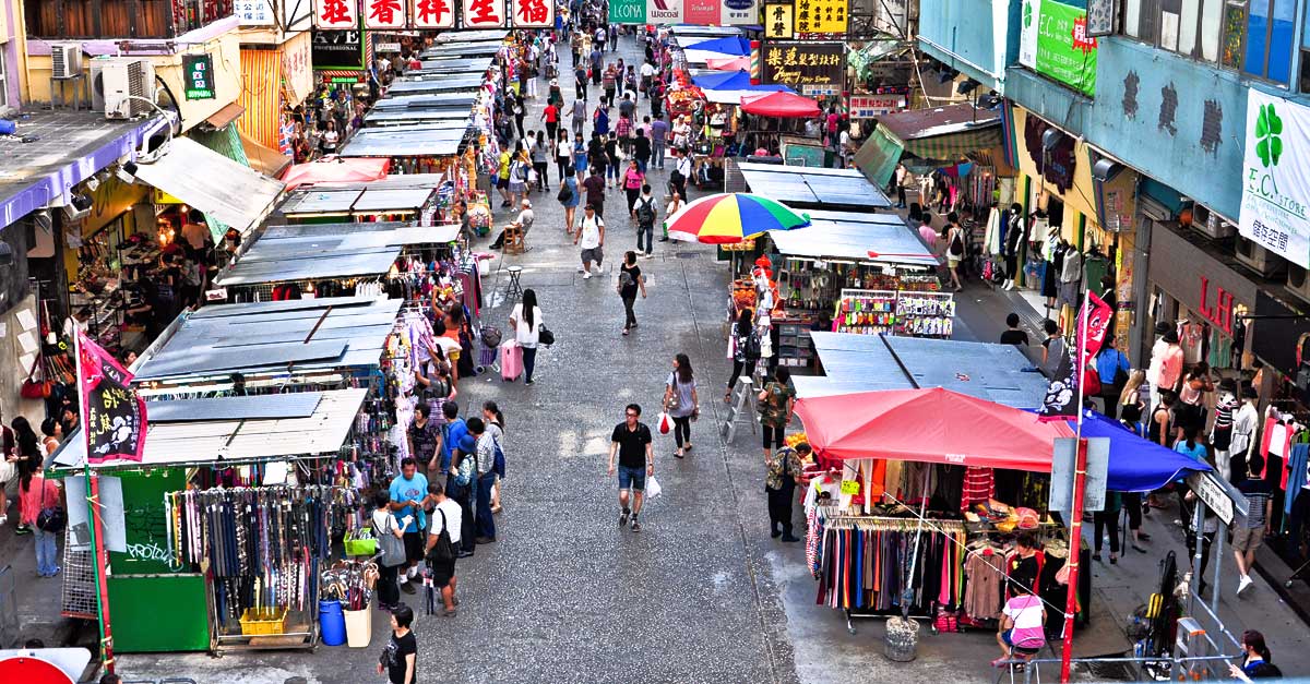 Busy overhead view of Sneakers Street market in Hong Kong, featuring colorful stalls selling sneakers and crowds of shoppers
