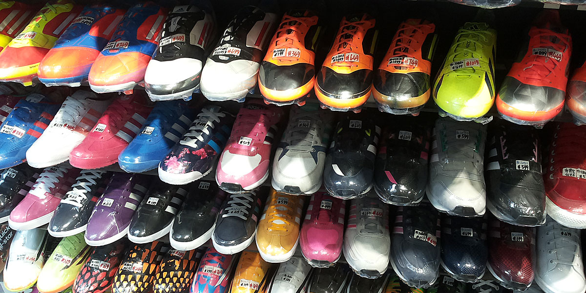 Colorful display of assorted Adidas sneakers on shelves in a Hong Kong sneaker shop
