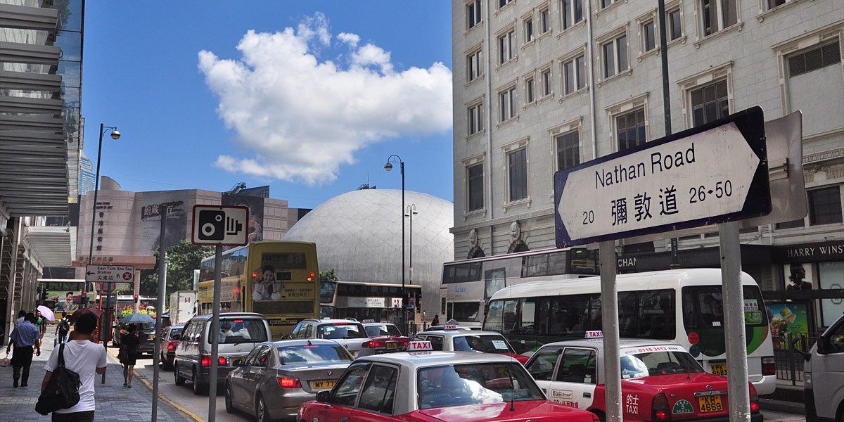 Busy traffic and pedestrians on Nathan Road near Mong Kok's Sneakers Street in Hong Kong